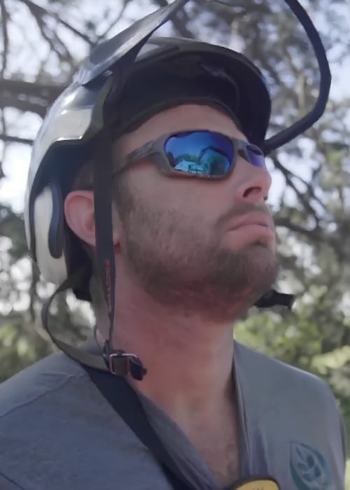 Close-up of Ostvig arborist wearing climbing helmet and safety glasses.