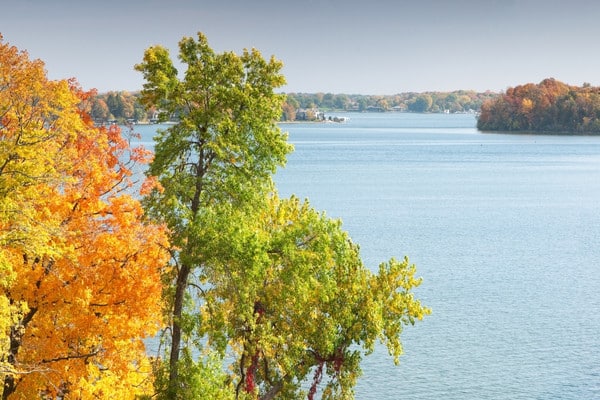 Lake view framed by trees in fall color along the shoreline.