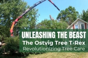 Crane truck arm reaching over a residential home to remove a large tree limb.